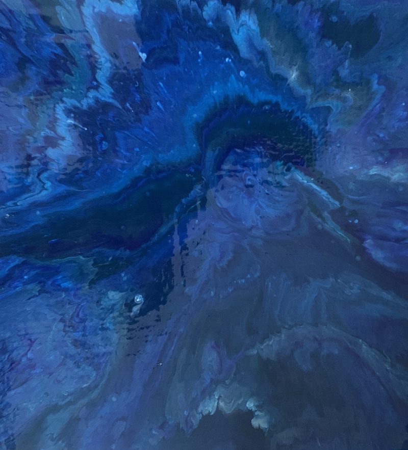 Deep indigo pour opening outward from a dark centre